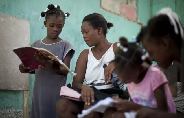 Nadege Auguste teaches her daughters at home. Access to education is a huge challenge in Haiti