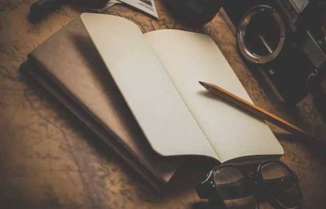 brown pencil on white notebook