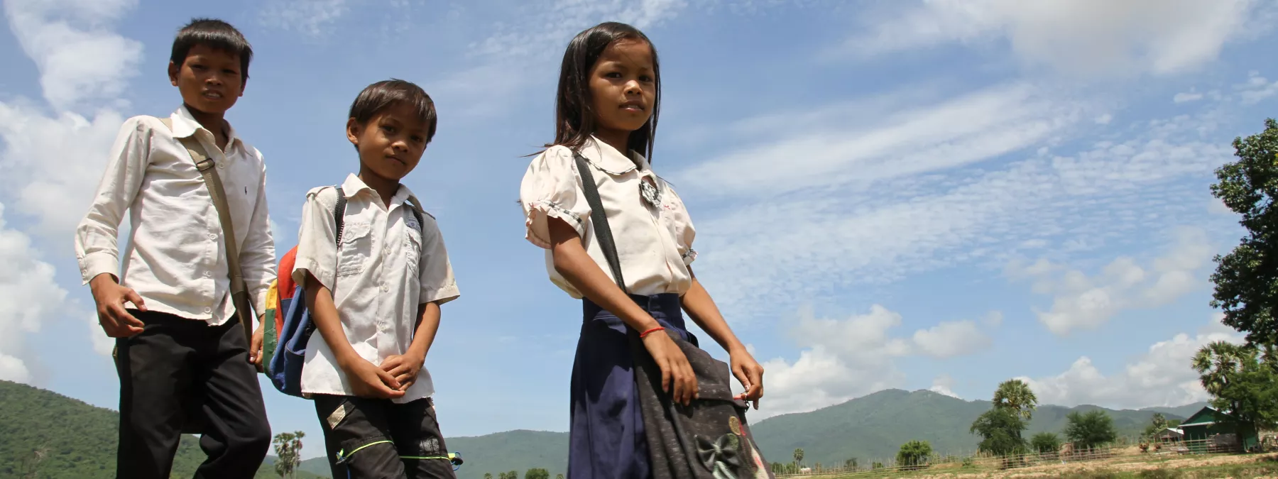 Srey Yeng, 8-year old girl, walking to school with her brothers.
